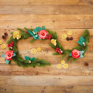Fir garland with flowers made from coloured paper